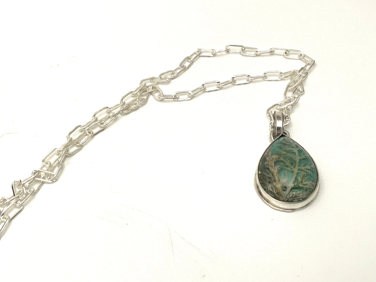 Nature-inspired silver resin cabochon necklace with magnified pressed flowers